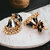 LUCKY JEWELLERY Gold Plated Black And White Color Floral Meenakari Jhumki Earring For Girls & Women (240-CHJM1-1146-BLW)