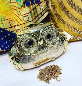 Owl Clutch in golden colour.